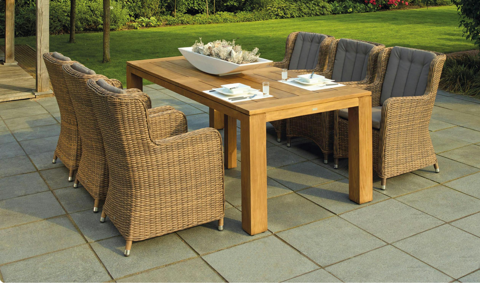 This image depicts an outdoor dining space with cozy yet functional furniture.
