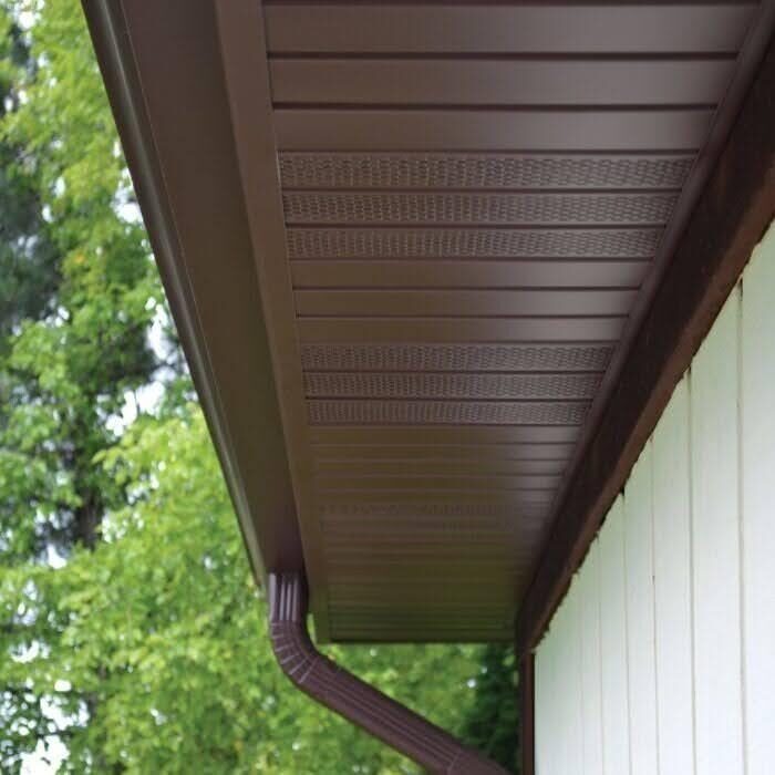 A Close Up Of Dark Brown Gutters And Matching Soffits From Rollex