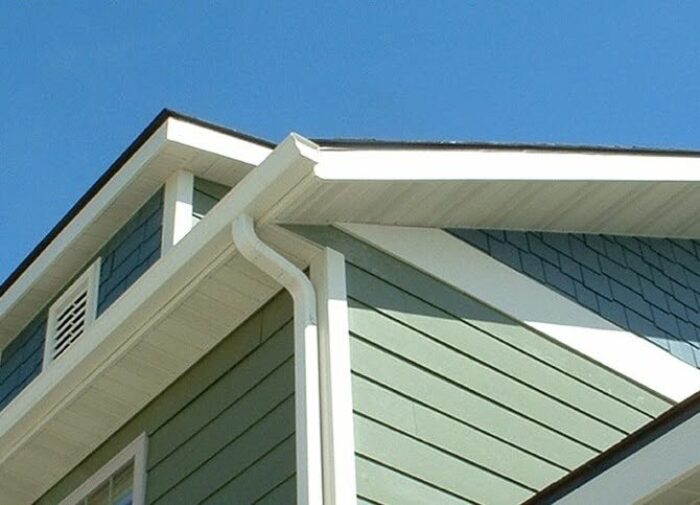 White Aluminum Soffit Paneling From Rollex Installed Beneath The Roofline Of An Olive Green Home