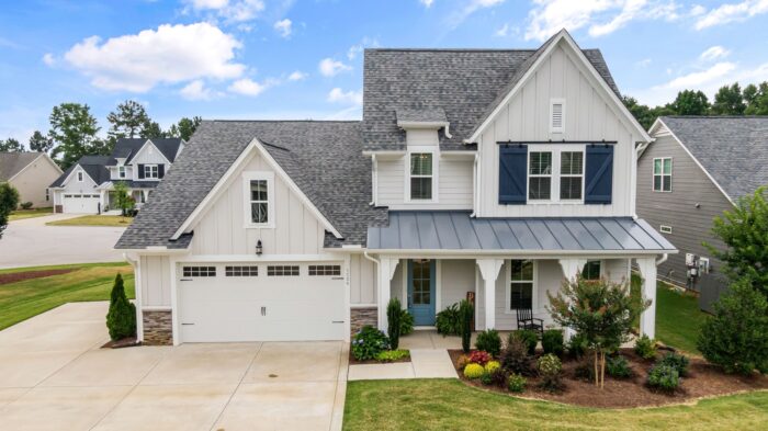 A home mixes vertical and horizontal siding and has white trim