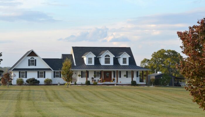 A two-story home has white horizontal vinyl siding and white trim.