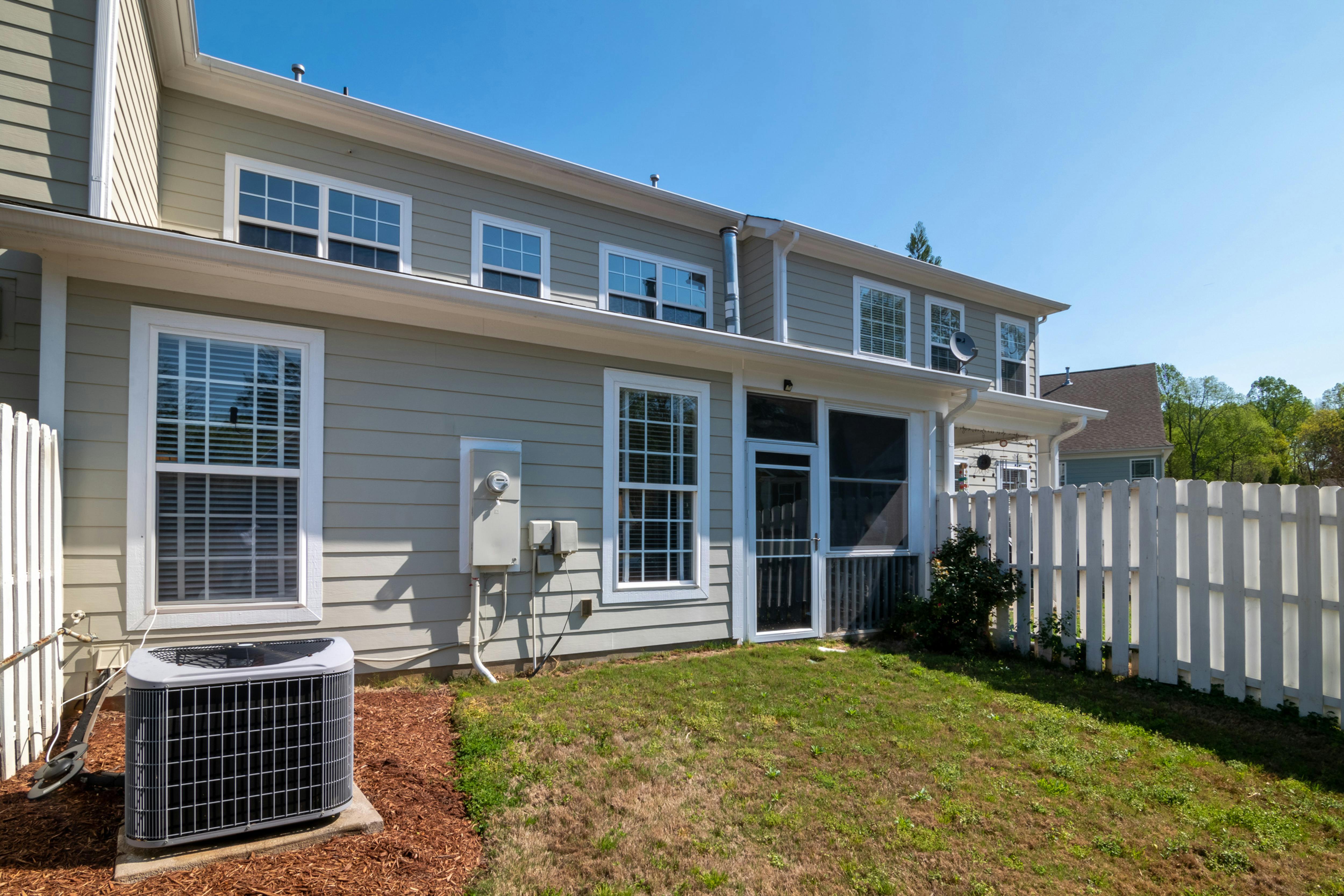 A modern home has a bump-out addition off the back of the house.