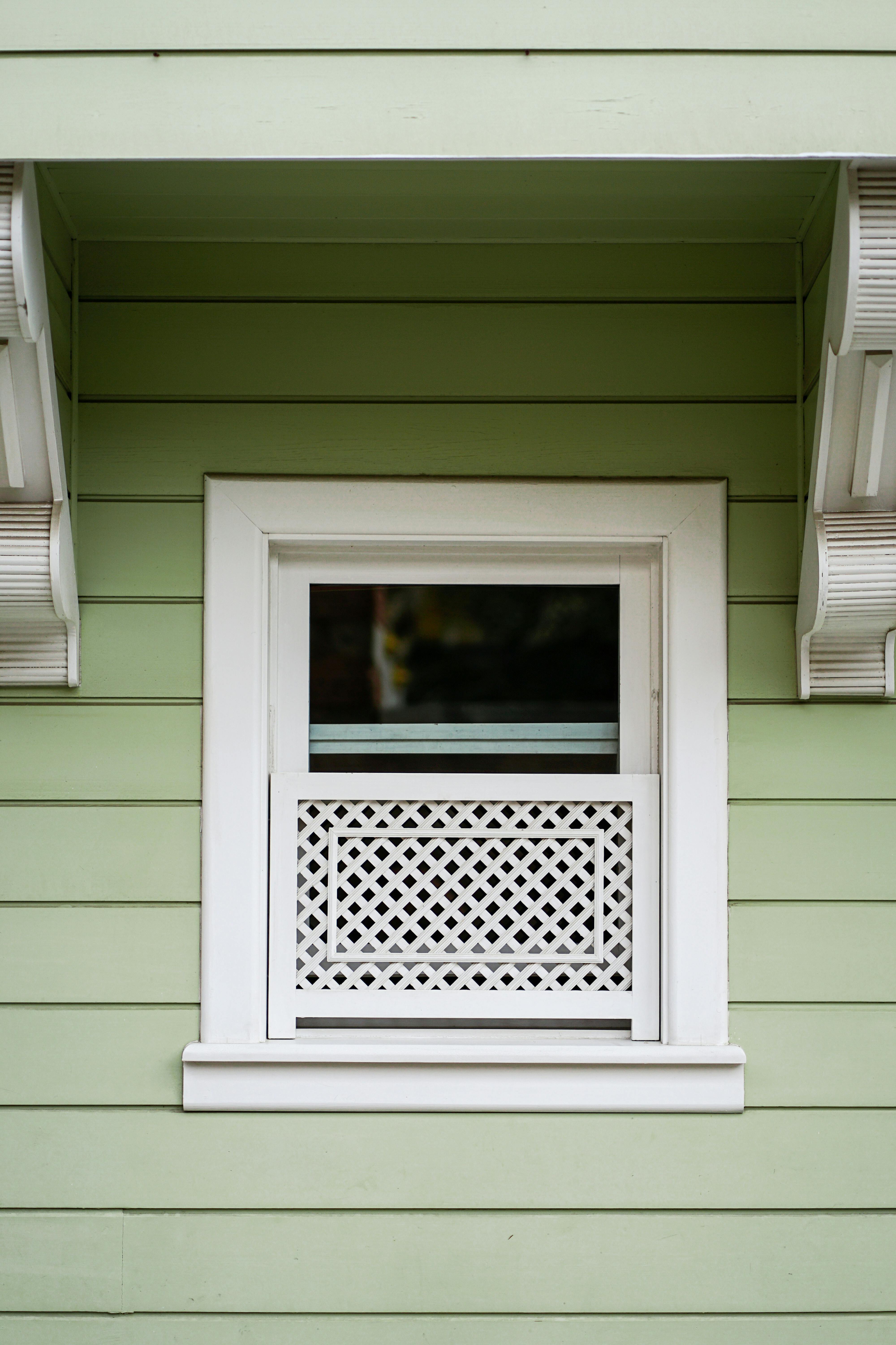 This image depicts a close-up view of green beaded lap siding.