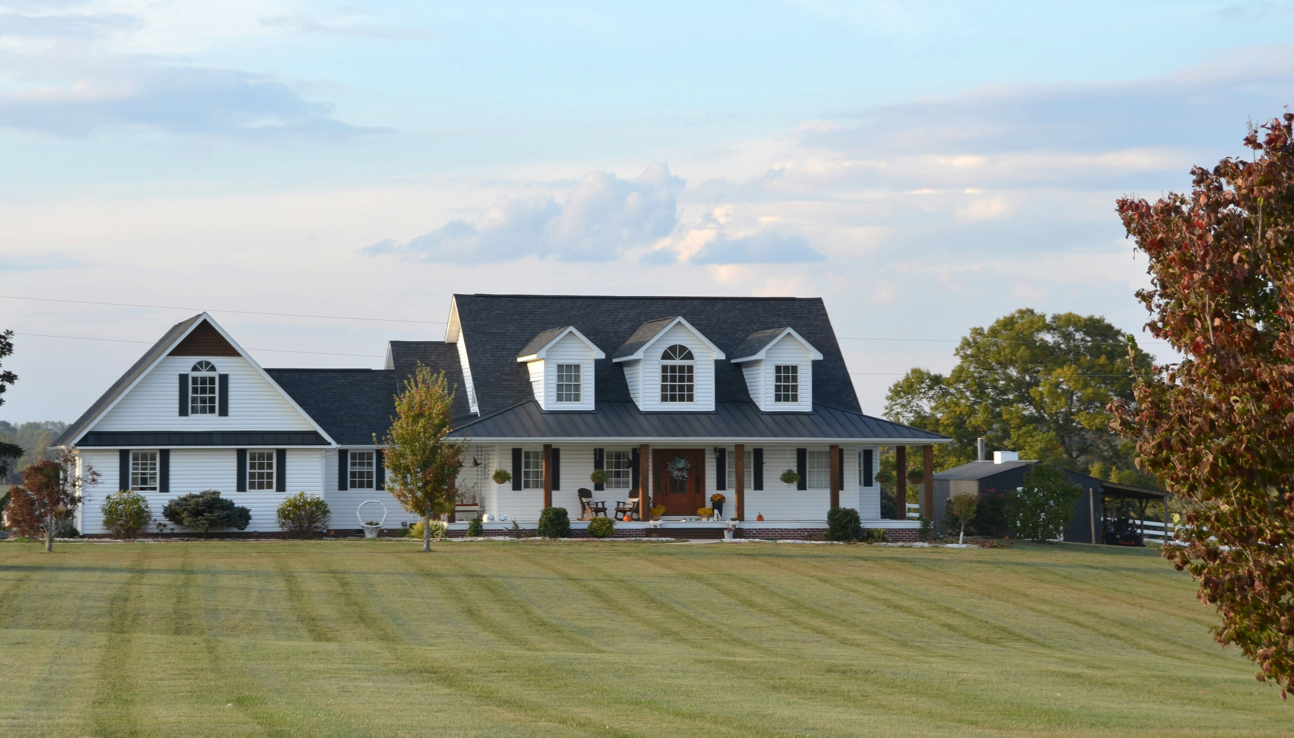 A two-story home has white horizontal vinyl siding and white trim.